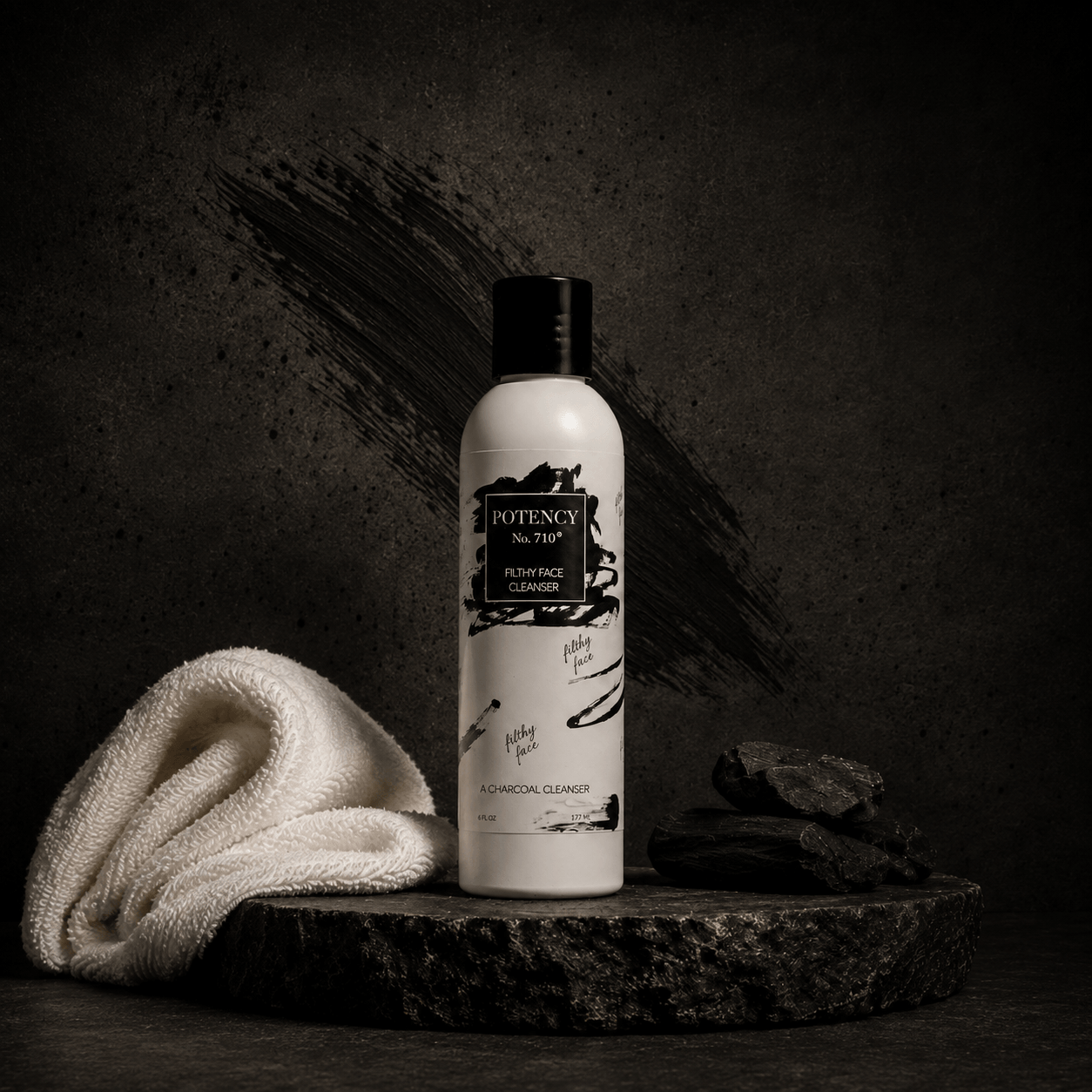 Potency No. 710 skincare bottle on dark stone beside a white towel