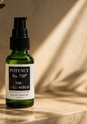 Green serum dropper bottle on travertine